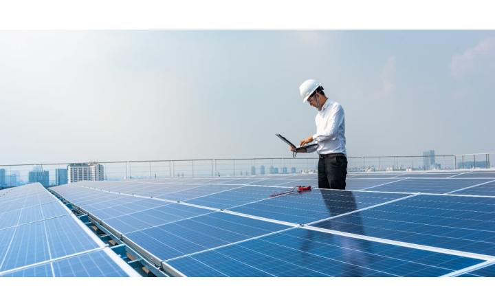 Electrical Engineer using equipment and laptop to measure solar panels