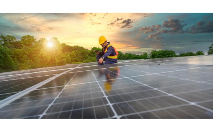 Worker installing Solar panels, for better sustainability.